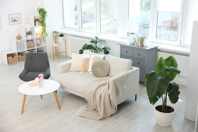 Photo of Comfortable sofa with coffee table and armchair in room, above view