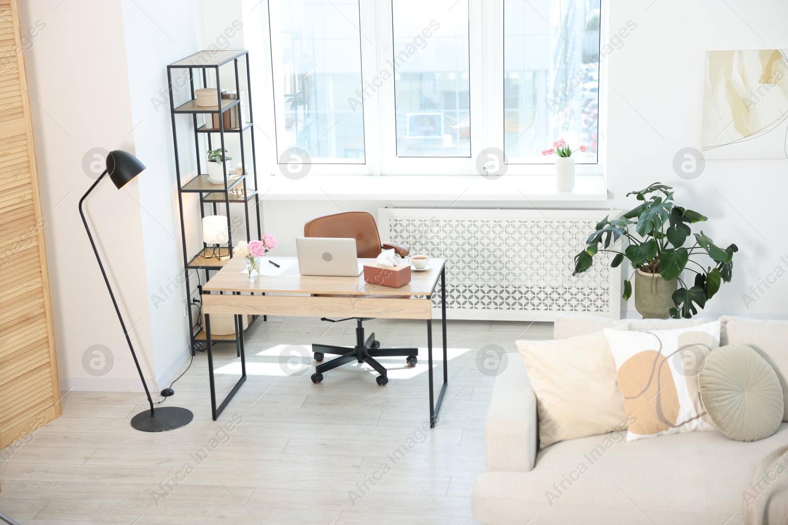 Desk with laptop in stylish room, above view Photo of Desk with laptop in stylish room, above view