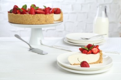 Photo of Delicious cheesecake with strawberries and mint on white wooden table, closeup