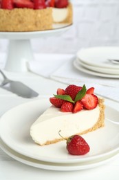 Photo of Piece of tasty cheesecake with strawberries and mint on white table, closeup