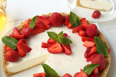 Photo of Delicious cheesecake with strawberries and mint on table, above view