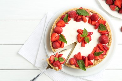 Photo of Delicious cheesecake with strawberries and mint on white wooden table, flat lay. Space for text