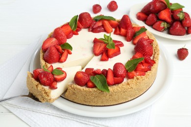 Photo of Delicious cheesecake with strawberries and mint on white wooden table, above view
