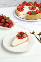 Photo of Delicious cheesecake with strawberries and mint on white wooden table, above view