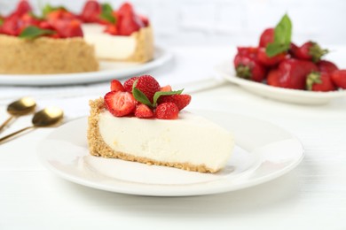 Photo of Piece of tasty cheesecake with strawberries and mint on white wooden table, closeup