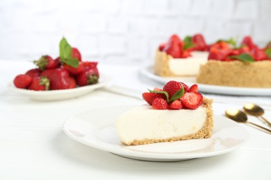 Photo of Piece of tasty cheesecake with strawberries and mint on white wooden table, closeup