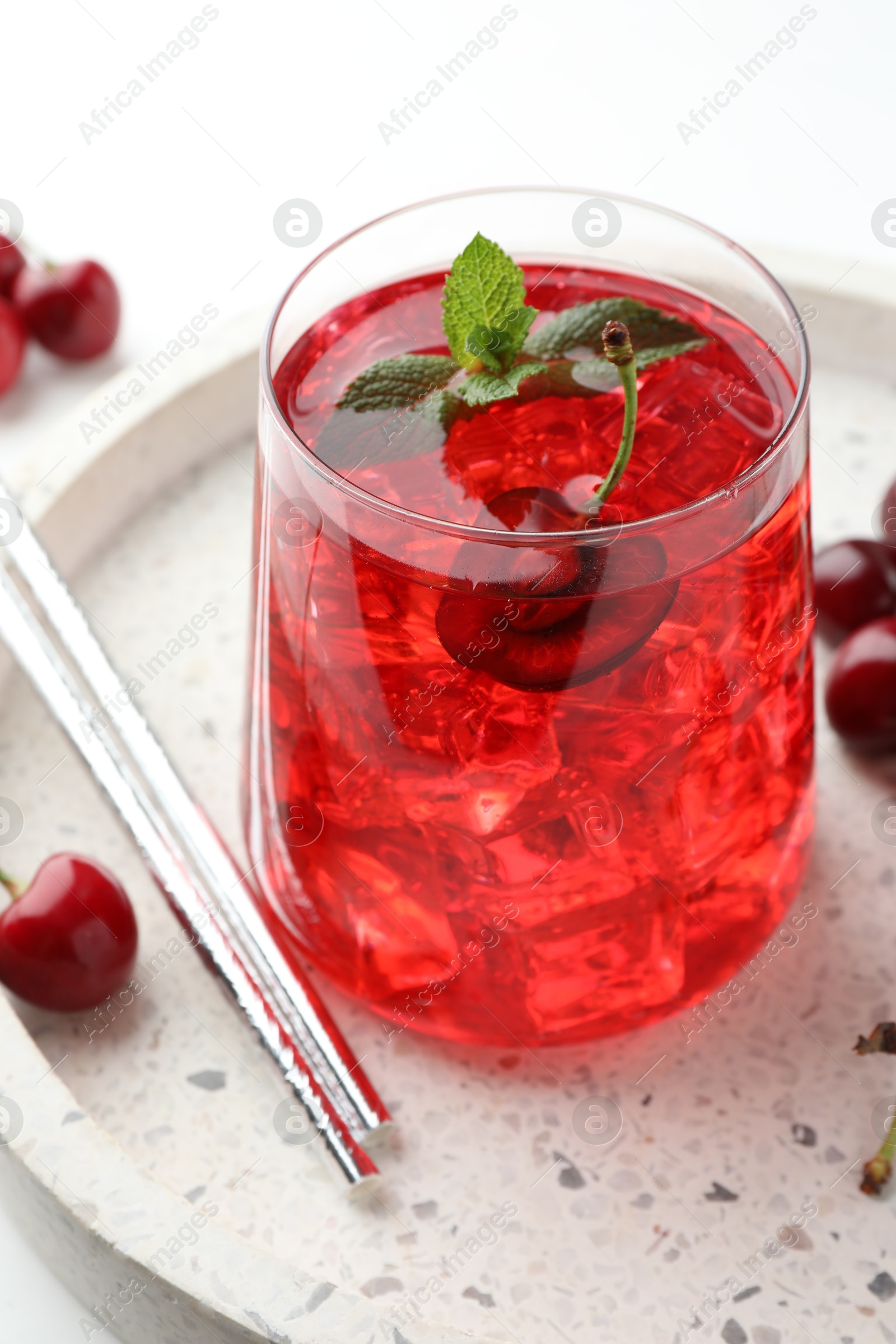 Tasty cherry soda with ice cubes, mint and berries on white table, closeup Photo of Tasty cherry soda with ice cubes, mint and berries on white table, closeup