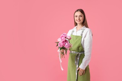 Photo of Florist with beautiful peonies on pink background, space for text