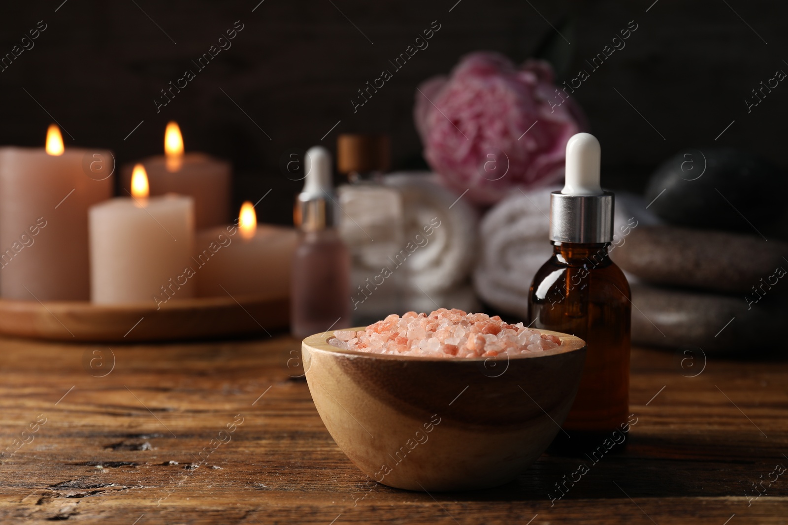 Spa composition with cosmetic products on wooden table against black background, closeup Photo of Spa composition with cosmetic products on wooden table against black background, closeup