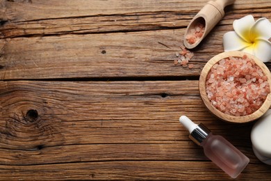 Photo of Flat lay composition with spa products and flower on wooden table. Space for text
