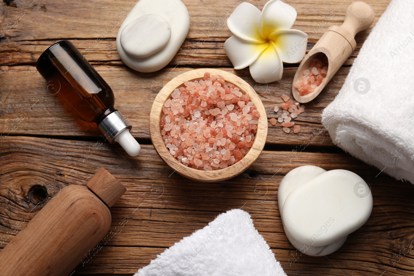 Spa products and towels on wooden table, above view Photo of Spa products and towels on wooden table, above view