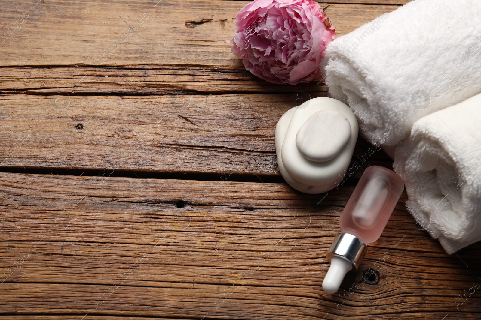 Spa products and flower on wooden table, above view. Space for text Photo of Spa products and flower on wooden table, above view. Space for text
