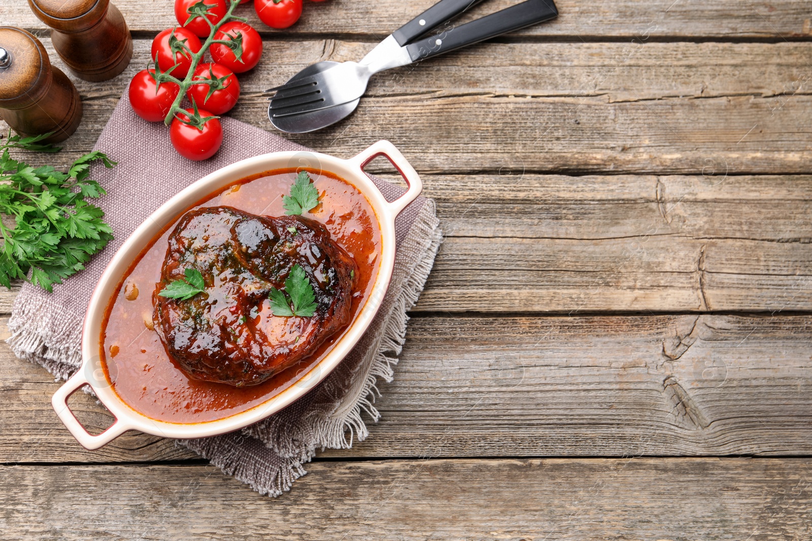Traditional ossobuco dish with beef steak served on wooden table, flat lay Photo of Traditional ossobuco dish with beef steak served on wooden table, flat lay