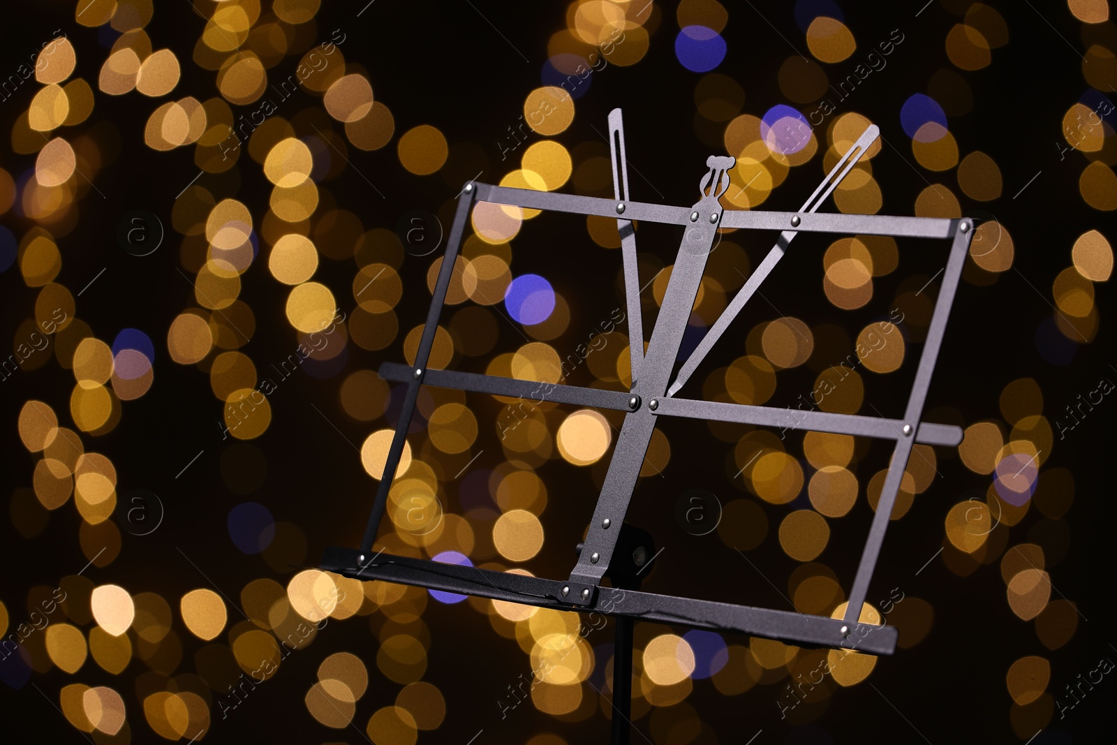 One empty note stand against blurred lights, closeup. Bokeh effect Photo of One empty note stand against blurred lights, closeup. Bokeh effect
