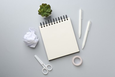 Photo of Flat lay composition with notebook on gray background
