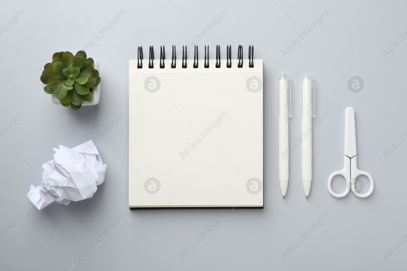 Photo of Flat lay composition with notebook on gray background