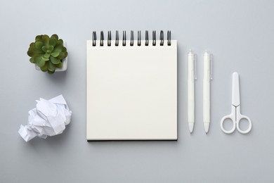 Photo of Flat lay composition with notebook on gray background