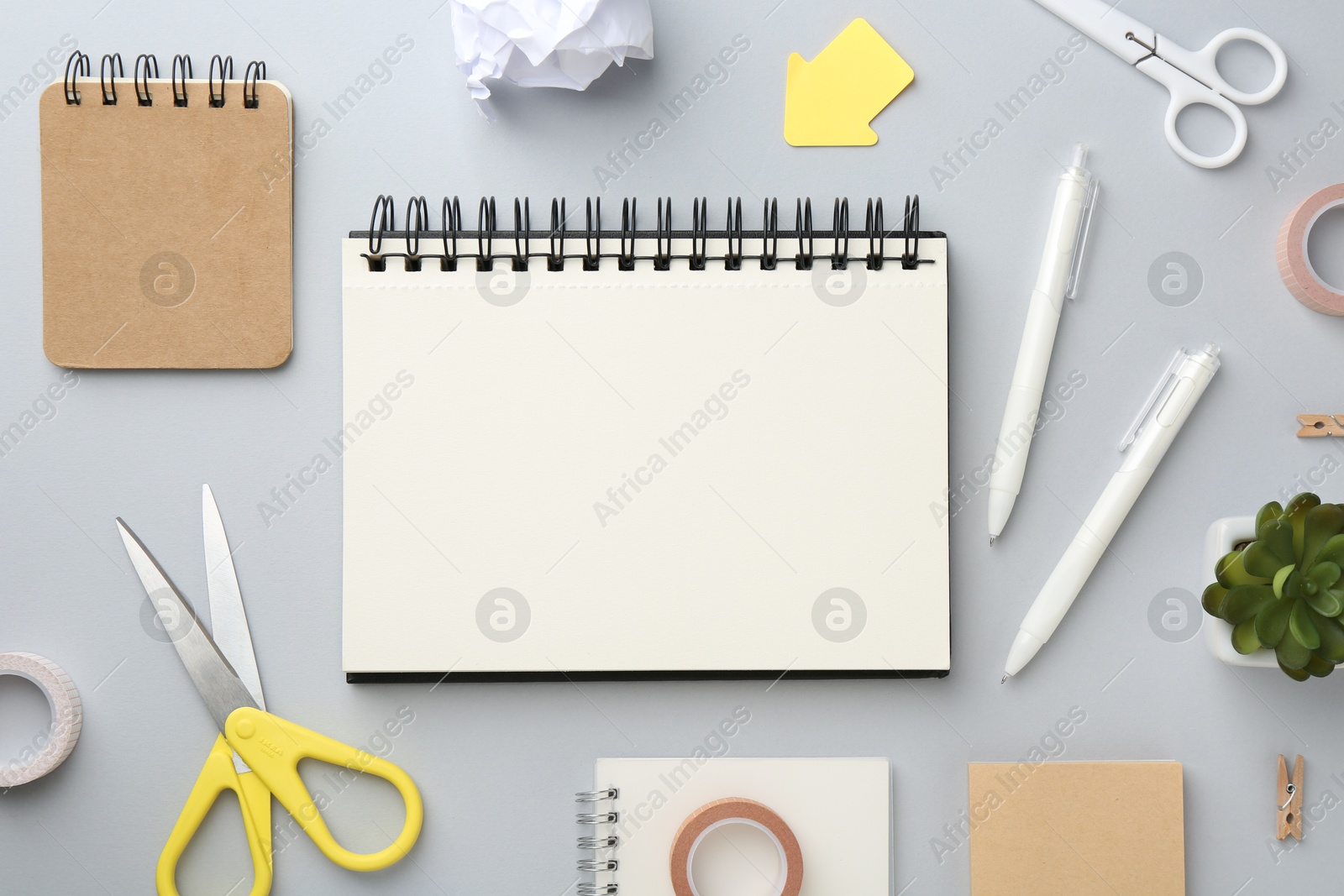 Photo of Flat lay composition with notebooks on gray background
