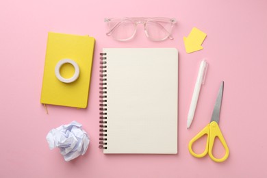 Photo of Flat lay composition with notebooks on pink background