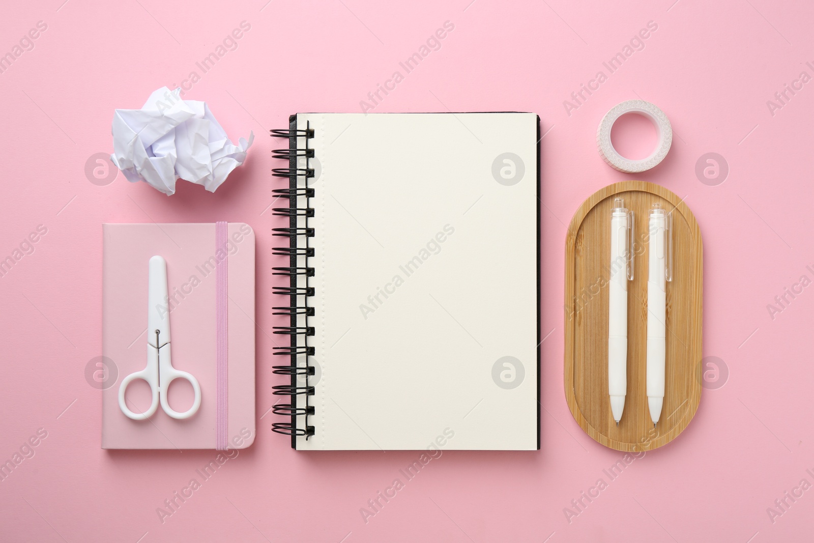 Photo of Flat lay composition with notebooks on pink background