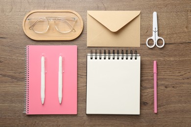 Photo of Flat lay composition with notebooks on wooden table