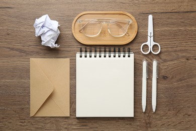 Photo of Flat lay composition with notebook on wooden table