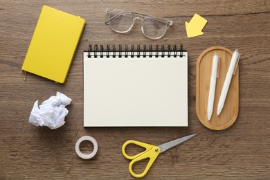 Photo of Flat lay composition with notebooks on wooden table