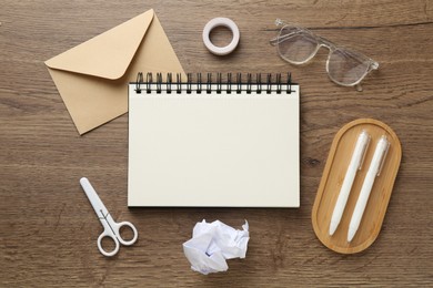 Photo of Flat lay composition with notebook on wooden table