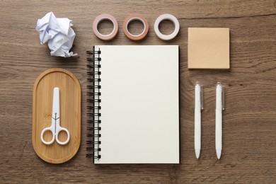 Photo of Flat lay composition with notebook on wooden table