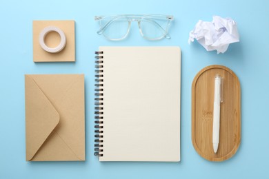 Photo of Flat lay composition with notebook on light blue background