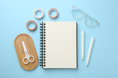 Photo of Flat lay composition with notebook on light blue background