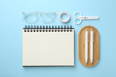 Photo of Flat lay composition with notebook on light blue background
