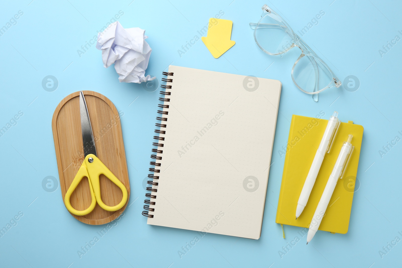 Flat lay composition with notebook on light blue background Photo of Flat lay composition with notebook on light blue background
