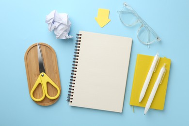 Photo of Flat lay composition with notebook on light blue background