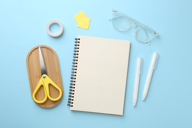 Photo of Flat lay composition with notebook on light blue background