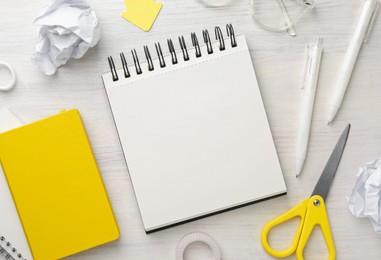 Photo of Flat lay composition with notebooks on light wooden table