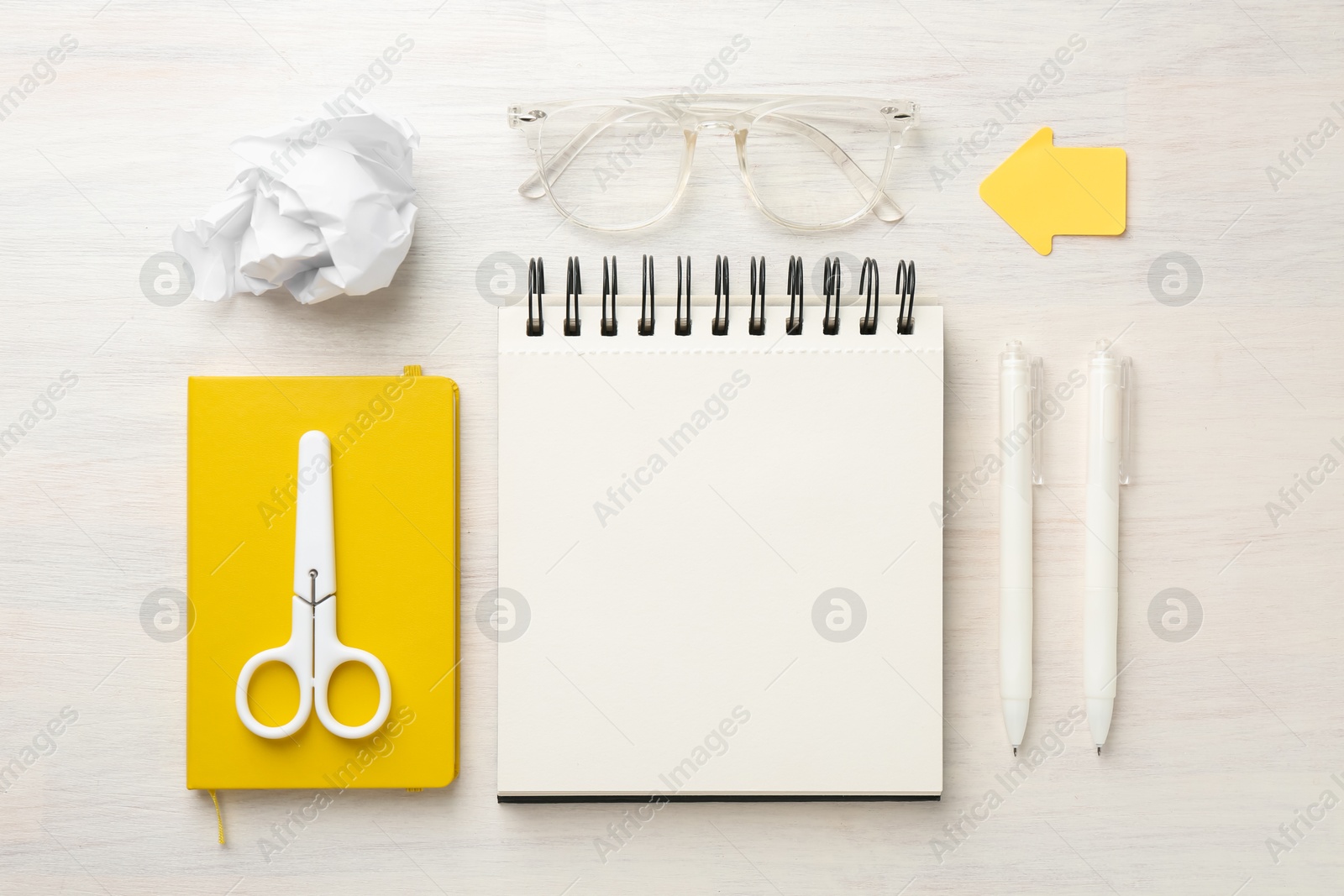 Flat lay composition with notebooks on light wooden table Photo of Flat lay composition with notebooks on light wooden table