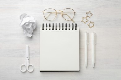 Photo of Flat lay composition with notebook on light wooden table