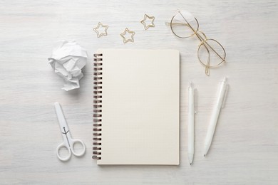 Photo of Flat lay composition with notebook on light wooden table
