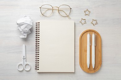 Photo of Flat lay composition with notebook on light wooden table
