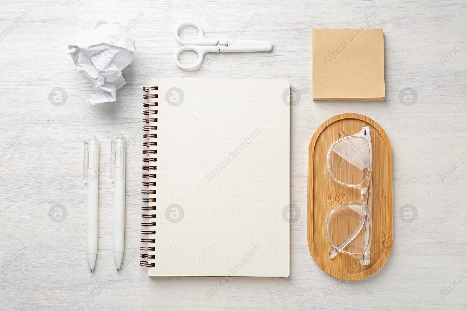 Flat lay composition with notebook on light wooden table Photo of Flat lay composition with notebook on light wooden table