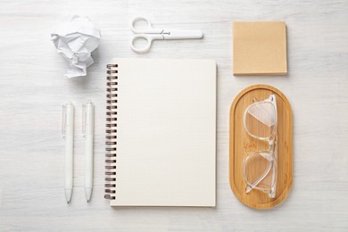 Photo of Flat lay composition with notebook on light wooden table