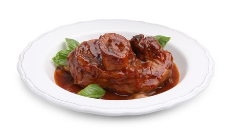 Photo of Traditional ossobuco dish with beef steak, sauce and basil isolated on white