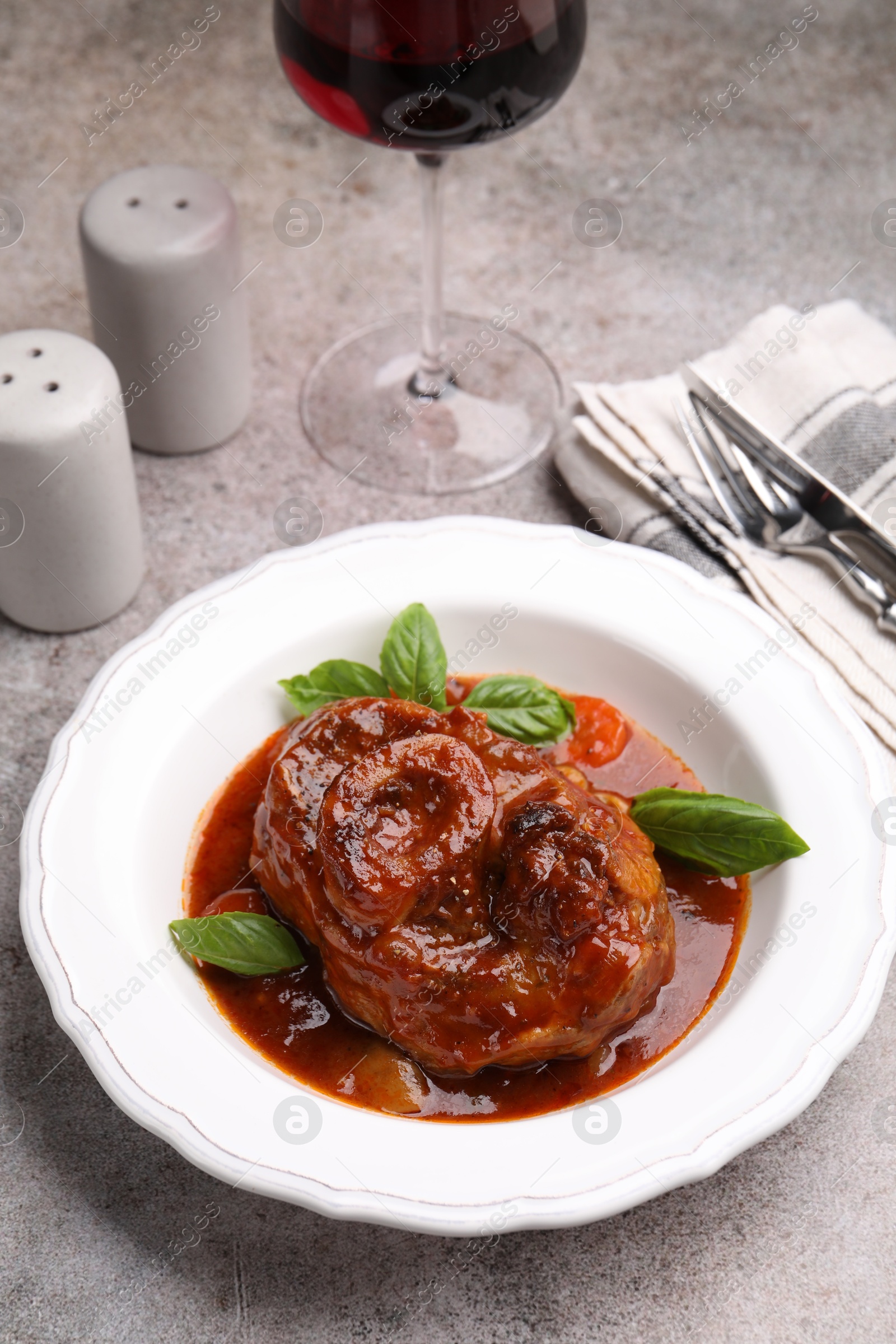 Traditional ossobuco dish with beef steak served on grey table, above view Photo of Traditional ossobuco dish with beef steak served on grey table, above view