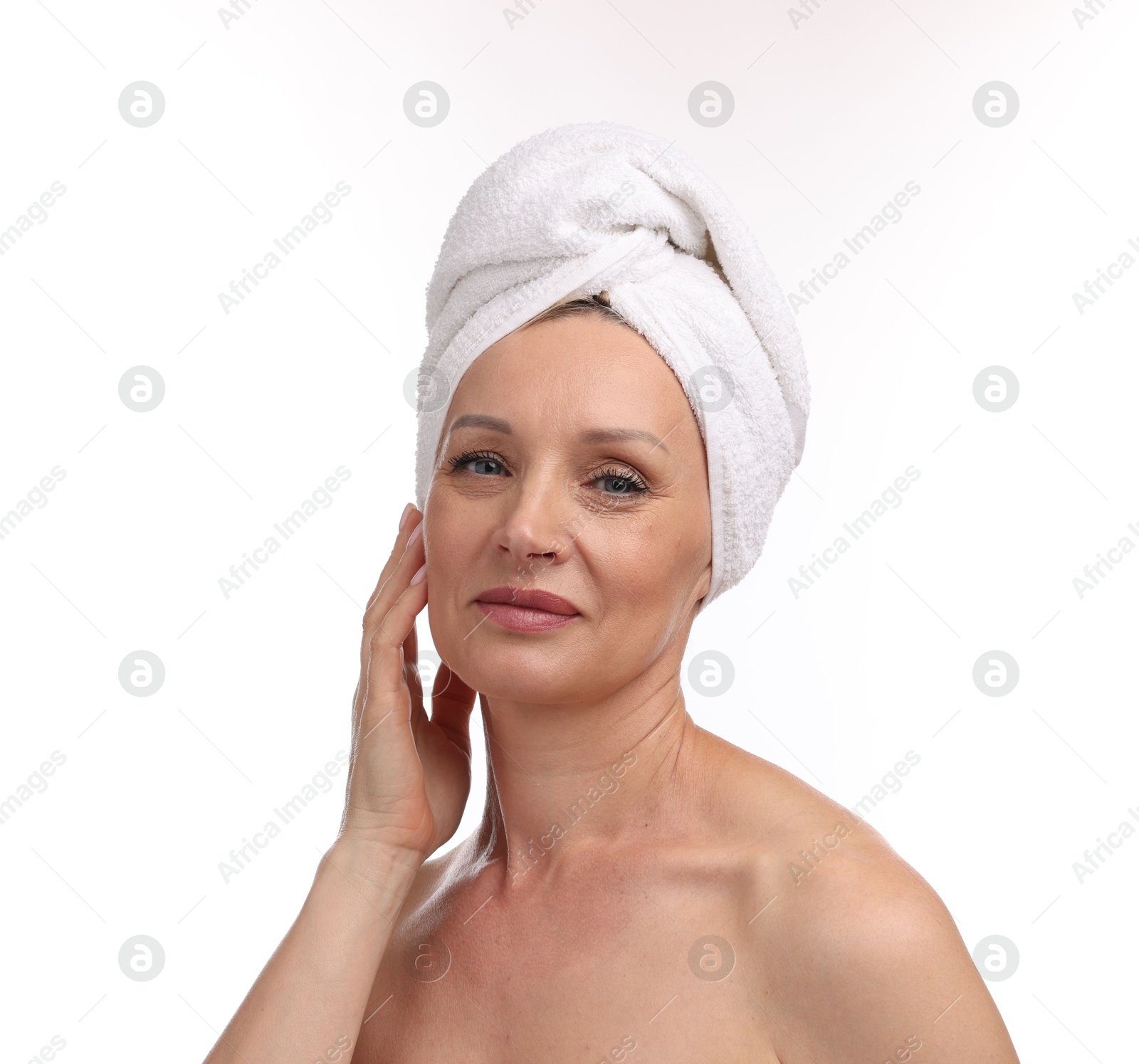 Beautiful woman with towel wrapped on her head against white background Photo of Beautiful woman with towel wrapped on her head against white background