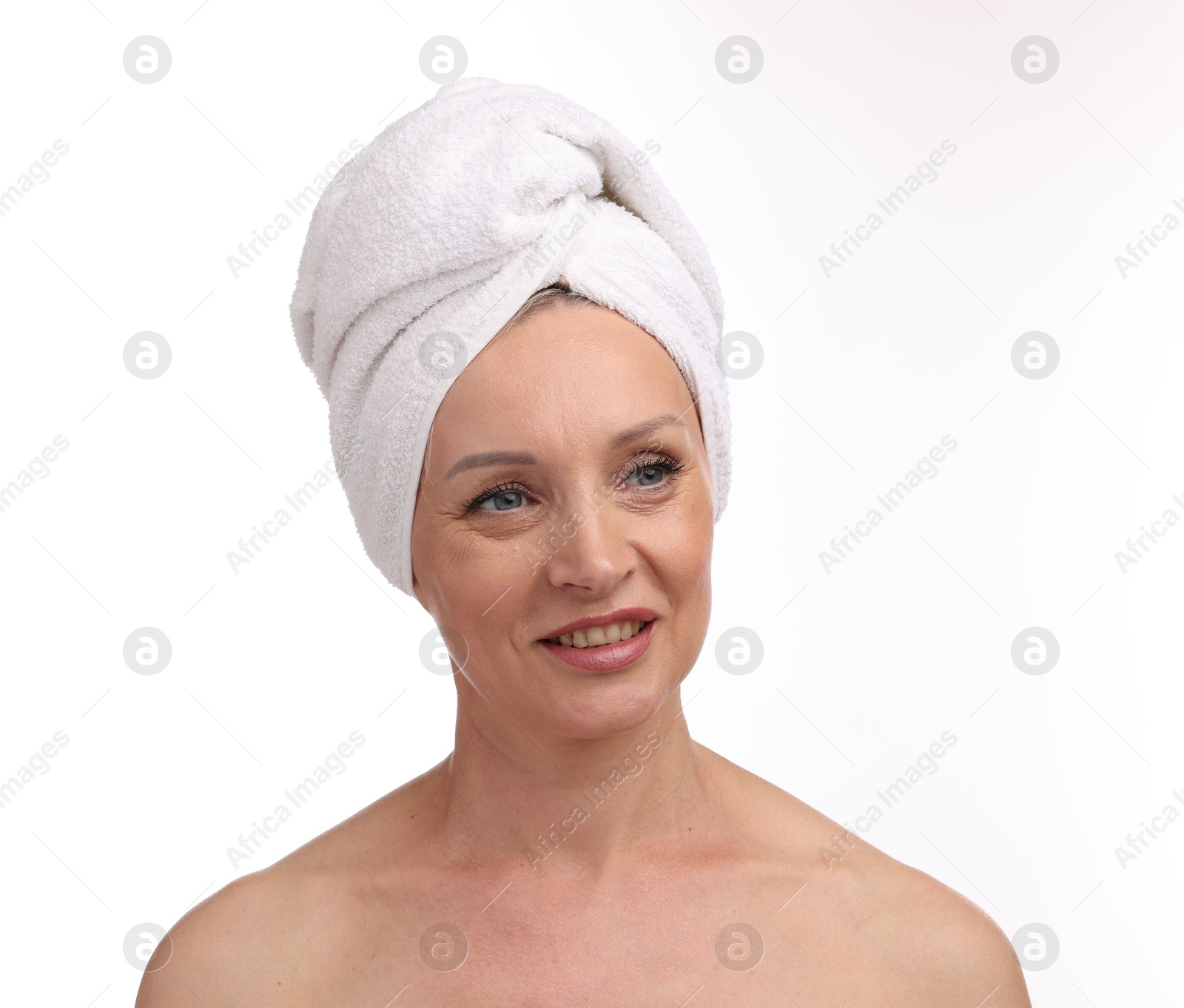 Beautiful woman with towel wrapped on her head against white background Photo of Beautiful woman with towel wrapped on her head against white background