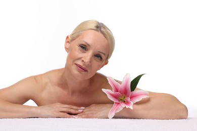 Photo of Beautiful woman with lily flower and towel on white background