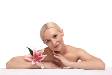 Photo of Beautiful woman with lily flower and towel on white background
