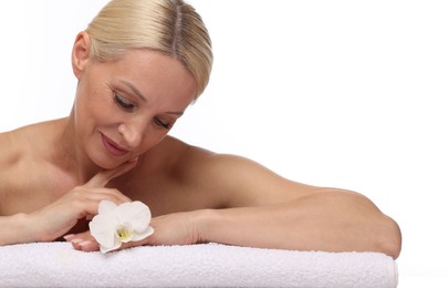 Photo of Beautiful woman with orchid flower and towel on white background
