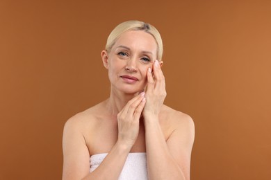 Photo of Portrait of beautiful woman on brown background